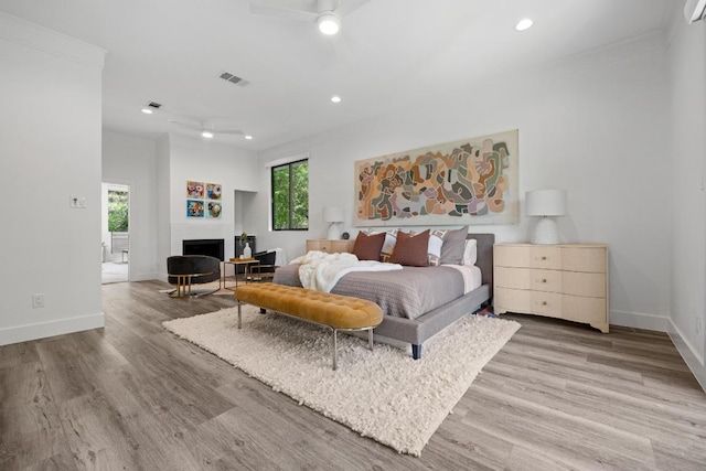 6103 Twin Ledge Dr, Austin, TX 78731 - bedroom featuring light wood finished floors, recessed lighting, a fireplace, and ceiling fan