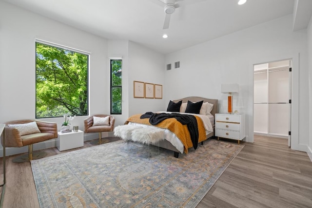 6103 Twin Ledge Dr, Austin, TX 78731 - bedroom featuring wood finished floors, recessed lighting, a walk in closet, and ceiling fan
