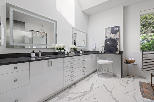 6103 Twin Ledge Dr, Austin, TX 78731 - full bath featuring double vanity, marble finish flooring, and a chandelier