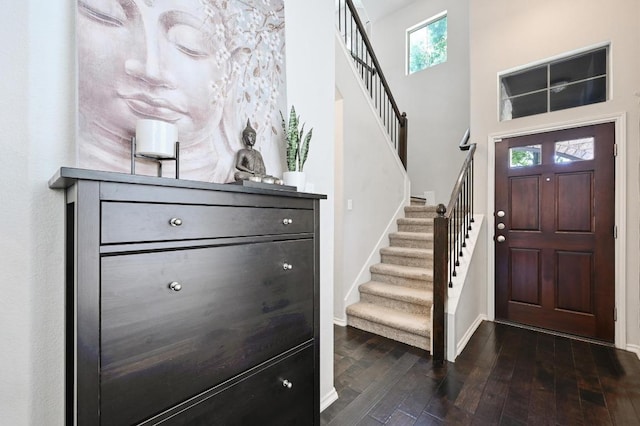 foyer entrance with baseboards, stairs, and a healthy amount of sunlight