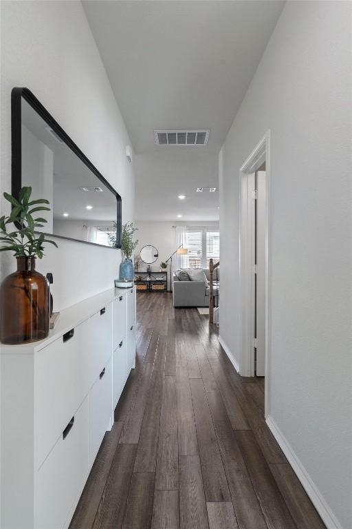 145 Fiery Skipper Ln, Georgetown, TX 78626 - corridor featuring dark wood-style floors, baseboards, and recessed lighting