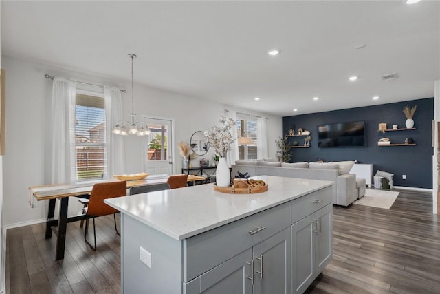 145 Fiery Skipper Ln, Georgetown, TX 78626 - kitchen with recessed lighting, dark wood-style floors, a kitchen island, light countertops, and pendant lighting