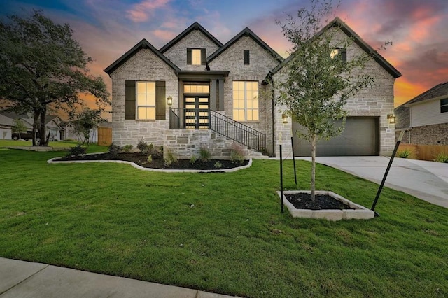 422 Quiet Oak Rd, San Marcos, TX 78666 - view of front of property with concrete driveway, stone siding, a garage, and a lawn
