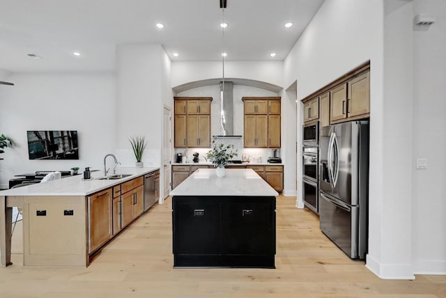 422 Quiet Oak Rd, San Marcos, TX 78666 - kitchen with wall chimney range hood, a center island, a sink, stainless steel appliances, and a peninsula