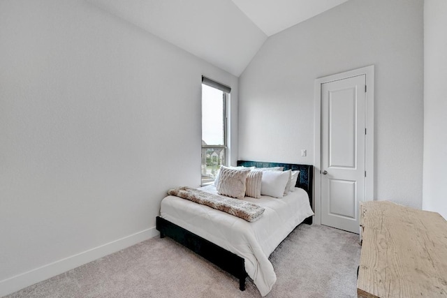 422 Quiet Oak Rd, San Marcos, TX 78666 - bedroom featuring lofted ceiling, baseboards, and light carpet