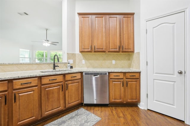 161 Caraway, Kyle, TX 78640 - kitchen with dishwasher, a sink, brown cabinetry, and ceiling fan