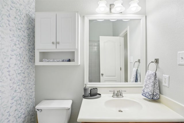 bathroom featuring toilet and vanity