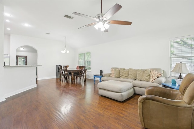 161 Caraway, Kyle, TX 78640 - living area with arched walkways, dark wood finished floors, a ceiling fan, vaulted ceiling, and a chandelier