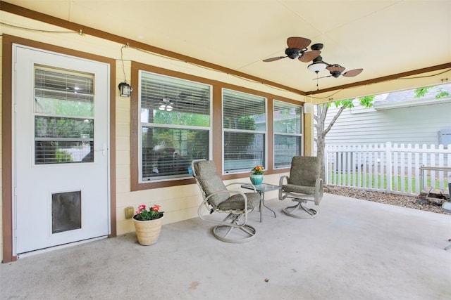 view of patio with ceiling fan, a porch, and fence