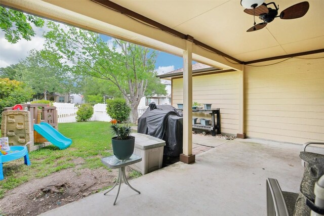 view of patio / terrace featuring fence, ceiling fan, a playground, and area for grilling
