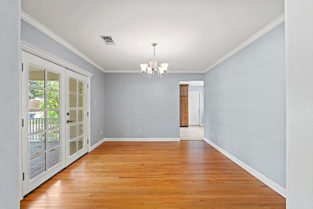 unfurnished dining area with light wood-style flooring, baseboards, visible vents, a chandelier, and ornamental molding