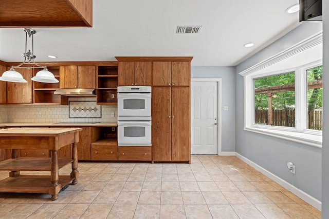kitchen with visible vents, backsplash, open shelves, under cabinet range hood, and double oven