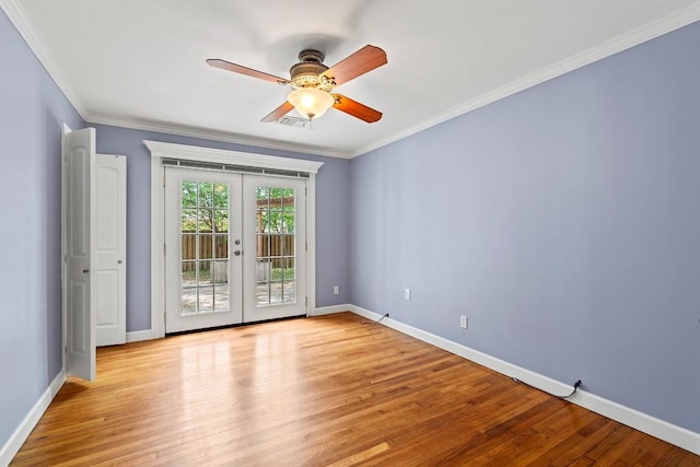 spare room with baseboards, ornamental molding, french doors, and light wood finished floors