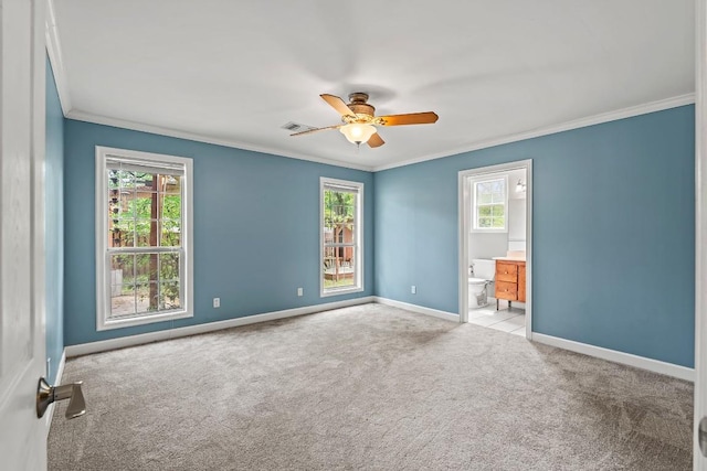 unfurnished room featuring ceiling fan, carpet floors, baseboards, and ornamental molding