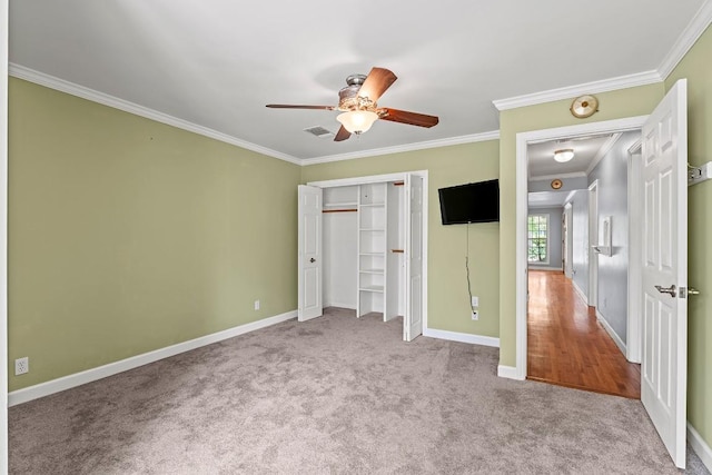 unfurnished bedroom featuring visible vents, baseboards, carpet, ceiling fan, and crown molding