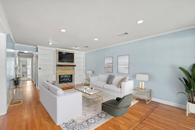 living area with baseboards, recessed lighting, light wood-style floors, and ornamental molding