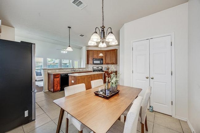 4001 Veiled Falls Dr, Pflugerville, TX 78660 - dining space featuring light tile patterned floors, a chandelier, and a ceiling fan