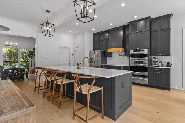 20 Hedgebrook Way, The Hills, TX 78738 - kitchen with a chandelier, a warming drawer, appliances with stainless steel finishes, light countertops, and light wood-style floors