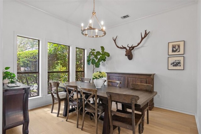 20 Hedgebrook Way, The Hills, TX 78738 - dining area featuring a chandelier, light wood-type flooring, and crown molding