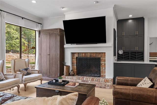 20 Hedgebrook Way, The Hills, TX 78738 - living area with crown molding, a brick fireplace, wood finished floors, and recessed lighting