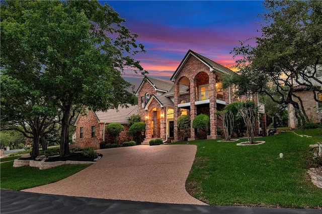 20 Hedgebrook Way, The Hills, TX 78738 - view of front of home with stone siding, curved driveway, and a front lawn