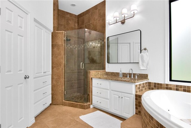 20 Hedgebrook Way, The Hills, TX 78738 - full bathroom with a shower stall, vanity, a garden tub, and tile patterned flooring