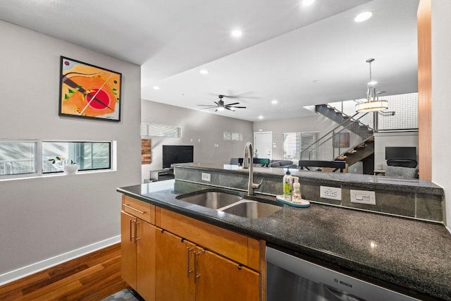 503 Swanee Dr Unit 11, Austin, TX 78752 - kitchen featuring dark wood-type flooring, open floor plan, recessed lighting, dishwashing machine, and dark stone counters
