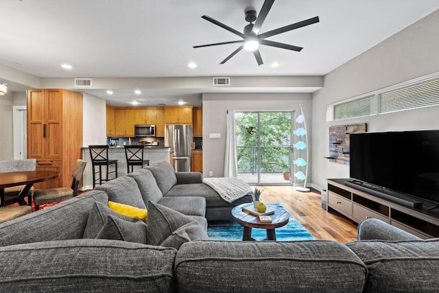 503 Swanee Dr Unit 11, Austin, TX 78752 - living room with light wood-type flooring, a ceiling fan, and recessed lighting