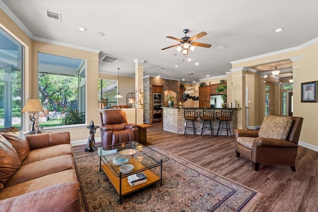 135 N Tumbleweed Trl, Austin, TX 78733 - living area featuring ornate columns, a ceiling fan, dark wood finished floors, crown molding, and recessed lighting