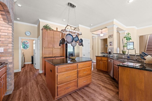 135 N Tumbleweed Trl, Austin, TX 78733 - kitchen with a center island, dishwasher, dark wood-style flooring, ornamental molding, and dark stone countertops