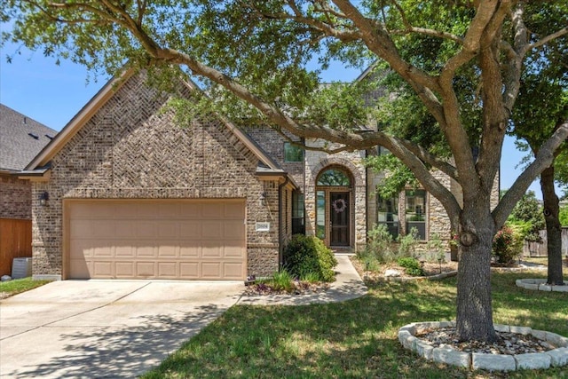 2604 Outlook Ridge Loop, Leander, TX 78641 - view of front of home featuring an attached garage, driveway, and brick siding