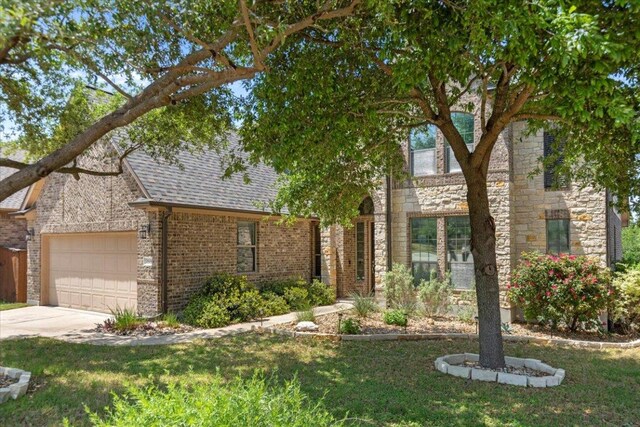 2604 Outlook Ridge Loop, Leander, TX 78641 - view of front of property with concrete driveway, a garage, and a front lawn