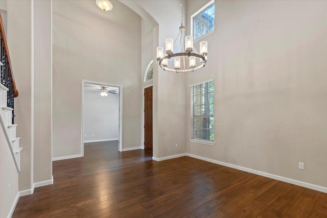 2604 Outlook Ridge Loop, Leander, TX 78641 - unfurnished dining area with a chandelier, hardwood / wood-style flooring, a towering ceiling, and baseboards
