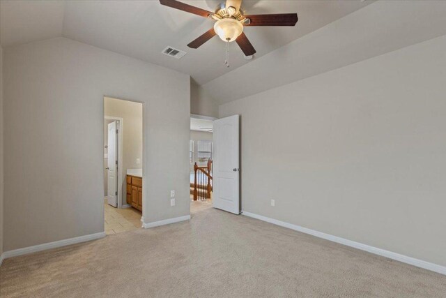 2604 Outlook Ridge Loop, Leander, TX 78641 - unfurnished bedroom featuring vaulted ceiling, light carpet, baseboards, ensuite bath, and ceiling fan