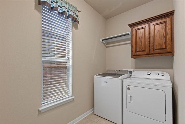2604 Outlook Ridge Loop, Leander, TX 78641 - laundry area with cabinet space, washing machine and clothes dryer, light tile patterned flooring, and baseboards