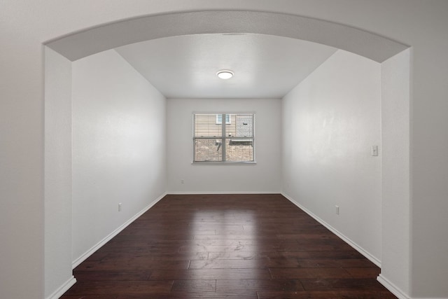 188 Rock Vista Run, Austin, TX 78737 - spare room with arched walkways, hardwood / wood-style flooring, and baseboards