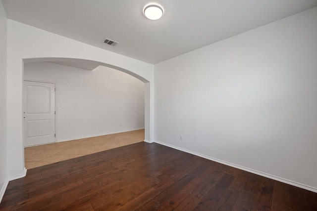 188 Rock Vista Run, Austin, TX 78737 - empty room with arched walkways, hardwood / wood-style flooring, and baseboards