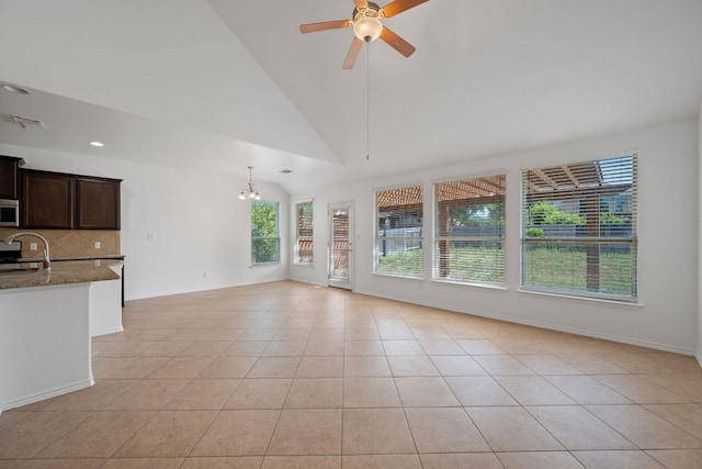 188 Rock Vista Run, Austin, TX 78737 - unfurnished living room with a ceiling fan, a sink, light tile patterned floors, lofted ceiling, and a chandelier