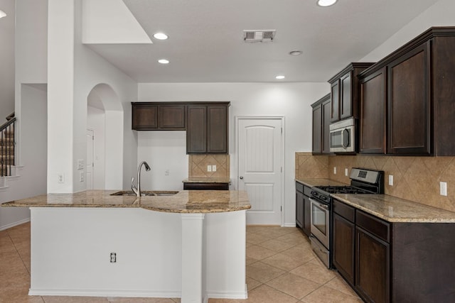 188 Rock Vista Run, Austin, TX 78737 - kitchen featuring appliances with stainless steel finishes, a sink, light stone countertops, light tile patterned floors, and recessed lighting