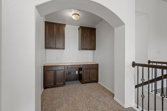 188 Rock Vista Run, Austin, TX 78737 - bar featuring light carpet, baseboards, built in desk, and arched walkways