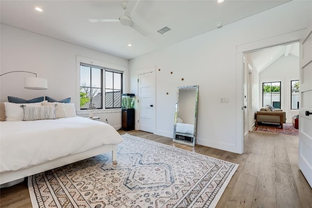 bedroom with lofted ceiling, baseboards, recessed lighting, and light wood-type flooring