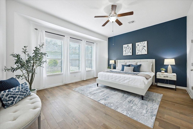 2216 Lookout Knoll Dr, Leander, TX 78641 - bedroom with wood finished floors, baseboards, and a ceiling fan