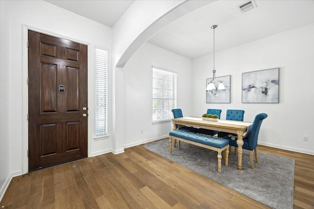 2216 Lookout Knoll Dr, Leander, TX 78641 - dining area featuring arched walkways, wood finished floors, baseboards, and a chandelier
