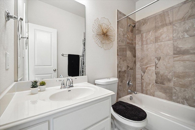 2216 Lookout Knoll Dr, Leander, TX 78641 - bathroom with toilet, vanity, bathtub / shower combination, and a textured wall