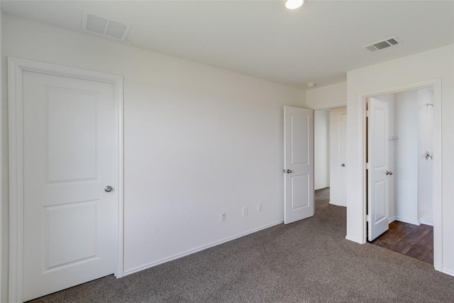 175 Safflower Dr, Uhland, TX 78640 - unfurnished bedroom featuring dark carpet and baseboards