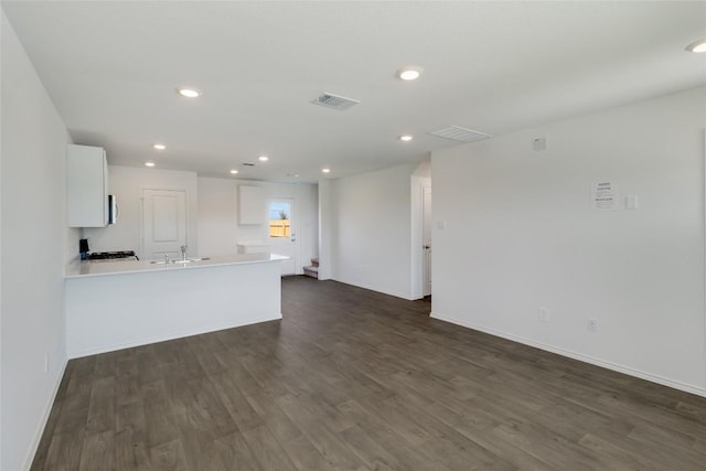 175 Safflower Dr, Uhland, TX 78640 - unfurnished living room featuring dark wood-style flooring and recessed lighting