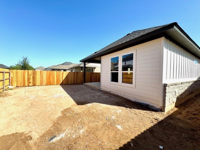 1155 Roger Hanks Pkwy, Dripping Springs, TX 78620 - view of side of property featuring a fenced backyard and board and batten siding