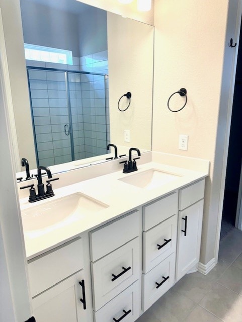 1155 Roger Hanks Pkwy, Dripping Springs, TX 78620 - bathroom featuring double vanity, tile patterned floors, and a stall shower