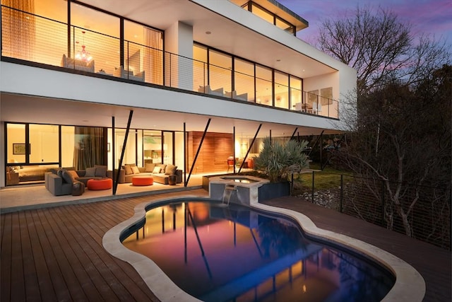 4607 Laurel Canyon Dr, Austin, TX 78731 - back of property with an outdoor hangout area, a pool with connected hot tub, stucco siding, and a balcony