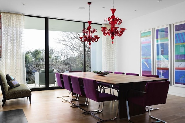 4607 Laurel Canyon Dr, Austin, TX 78731 - dining room featuring a wall of windows, wood finished floors, and a chandelier